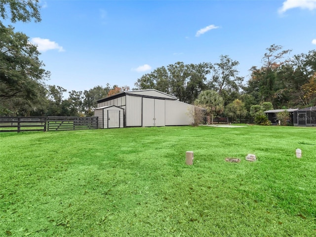 view of yard with a rural view and an outdoor structure