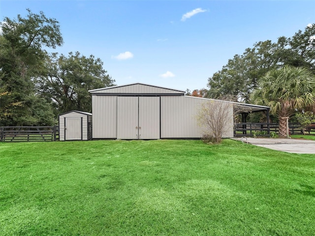 view of outbuilding with a yard