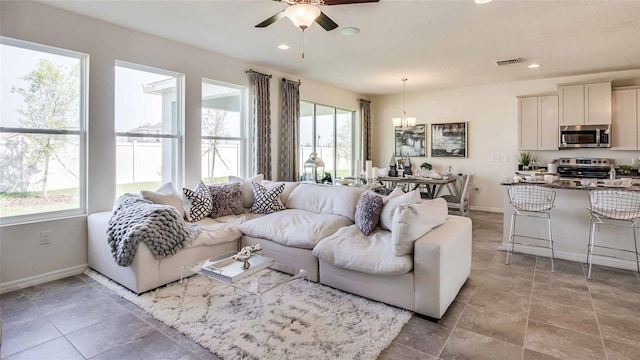 living room with baseboards, ceiling fan with notable chandelier, visible vents, and recessed lighting