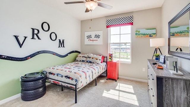 bedroom featuring baseboards, ceiling fan, and light colored carpet