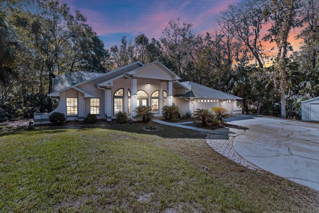 view of front facade featuring a lawn and a garage