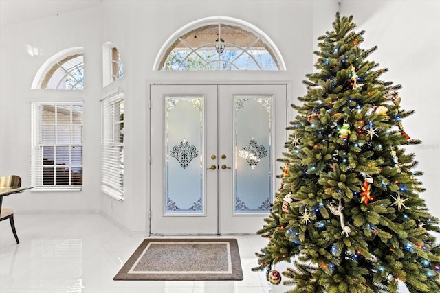 foyer entrance featuring tile patterned floors, a wealth of natural light, and french doors