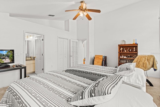 carpeted bedroom with connected bathroom, ceiling fan, a closet, and lofted ceiling