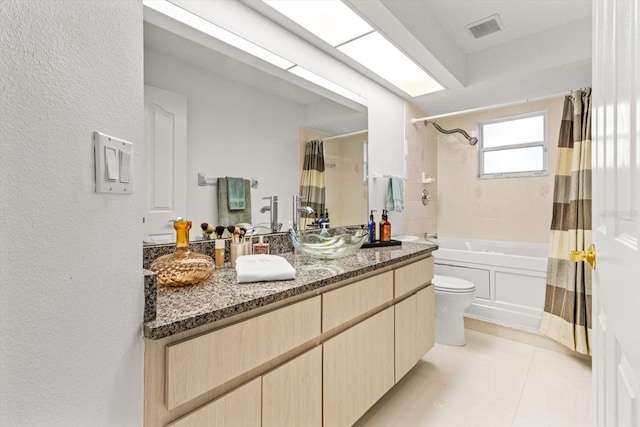 full bathroom featuring tile patterned floors, shower / bathtub combination with curtain, vanity, and toilet