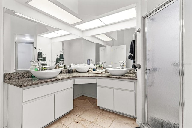 bathroom featuring vanity and a shower with shower door