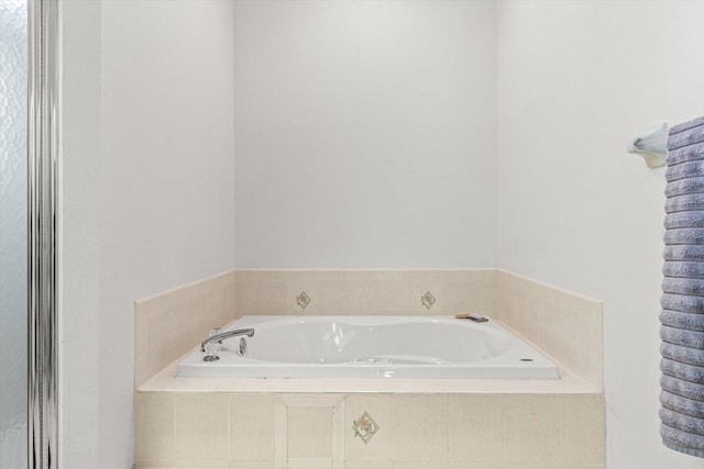 bathroom featuring a relaxing tiled tub