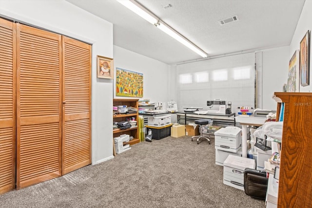 office with carpet and a textured ceiling