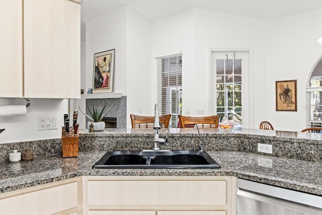 kitchen with dishwasher, light brown cabinets, and sink