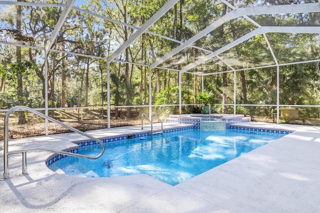 view of swimming pool with an in ground hot tub, glass enclosure, and a patio area