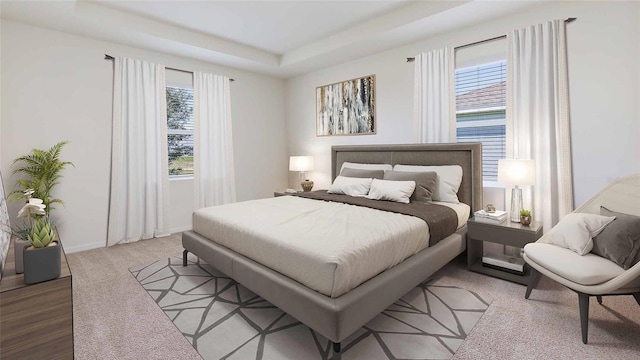 carpeted bedroom with a tray ceiling and multiple windows