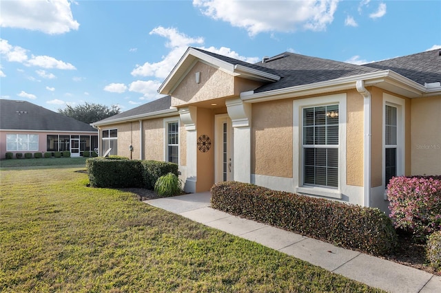 entrance to property with a yard