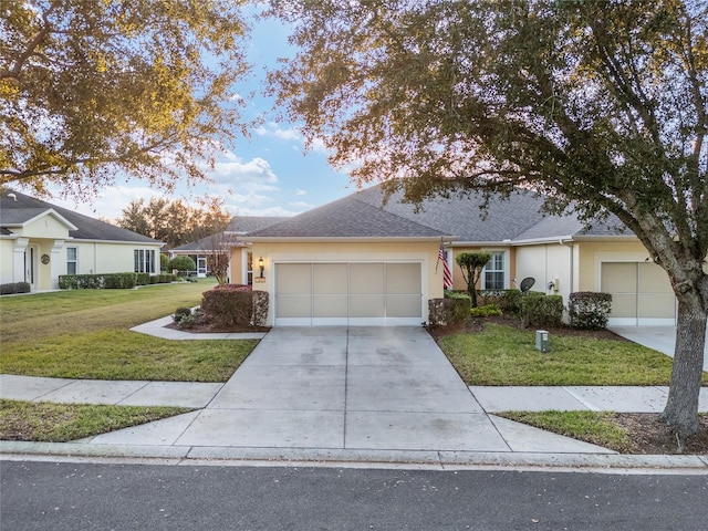 ranch-style home featuring a garage and a front yard