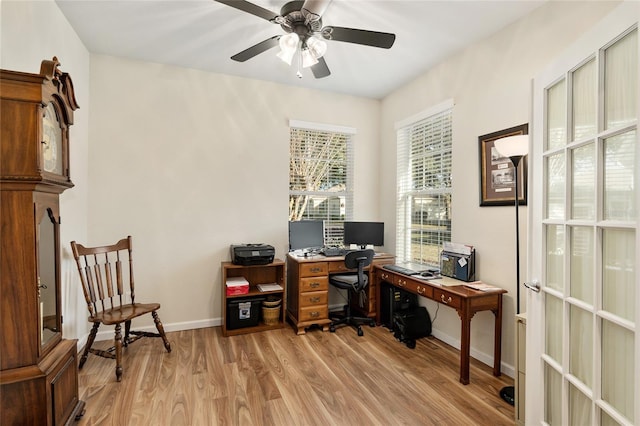 home office with ceiling fan and light hardwood / wood-style flooring