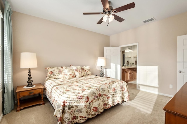 carpeted bedroom featuring ceiling fan and connected bathroom