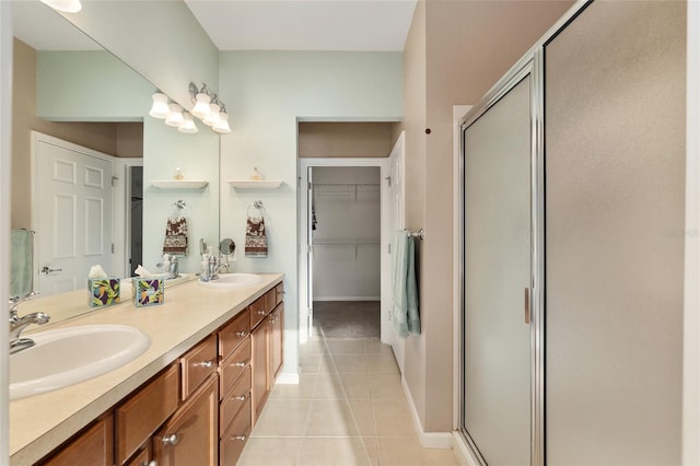 bathroom featuring vanity, tile patterned floors, and walk in shower