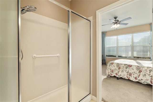 bathroom featuring a shower with door and ceiling fan