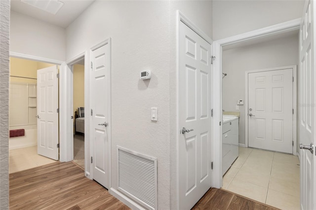 corridor with light wood-type flooring