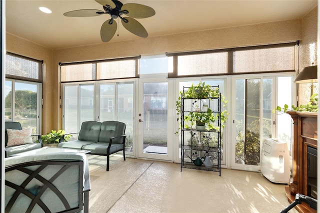 sunroom / solarium with plenty of natural light and ceiling fan