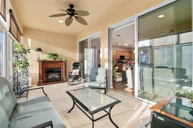 sunroom featuring plenty of natural light and ceiling fan