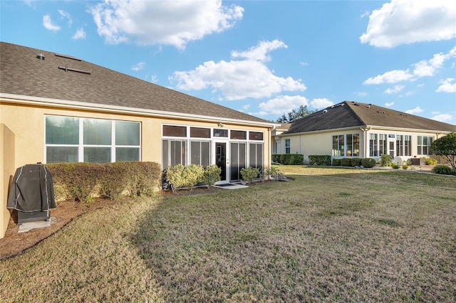 rear view of property with a yard