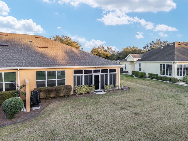 rear view of house with a yard