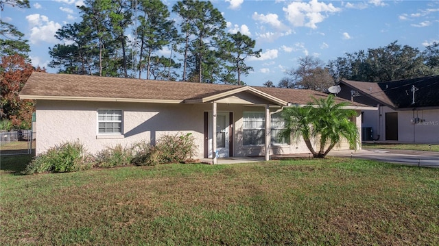 view of front facade with central AC unit and a front yard