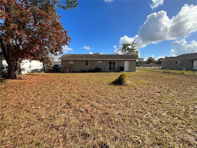 rear view of property with a yard