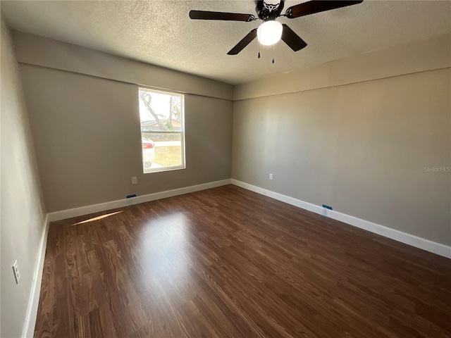 spare room with a textured ceiling, ceiling fan, and dark hardwood / wood-style floors