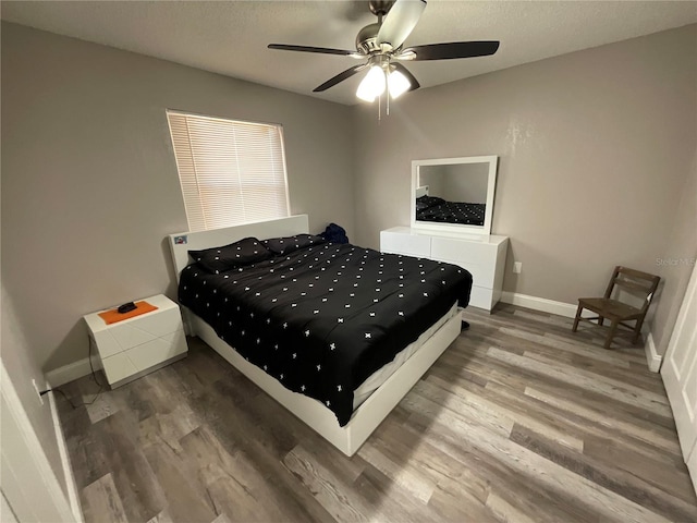 bedroom with ceiling fan and hardwood / wood-style flooring