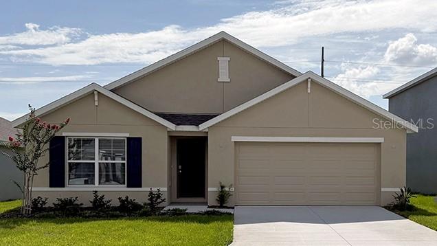 8878 SW 48th Ave, Ocala, FL 34476 - view of front of home featuring concrete driveway, a garage, a front lawn, and stucco siding