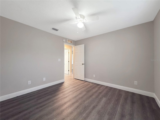 unfurnished room featuring dark hardwood / wood-style floors and ceiling fan