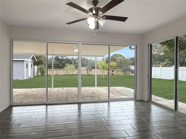 doorway to outside featuring ceiling fan