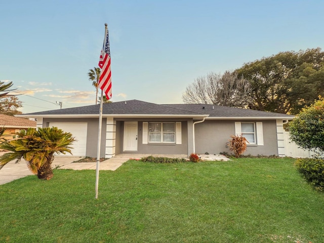 single story home with a garage and a front yard