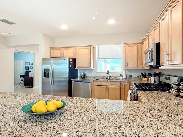 kitchen featuring light brown cabinets, sink, and stainless steel appliances