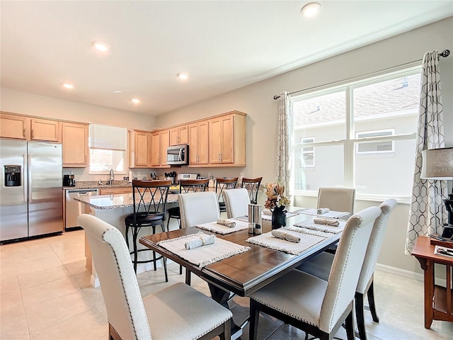 dining room with sink and light tile patterned floors