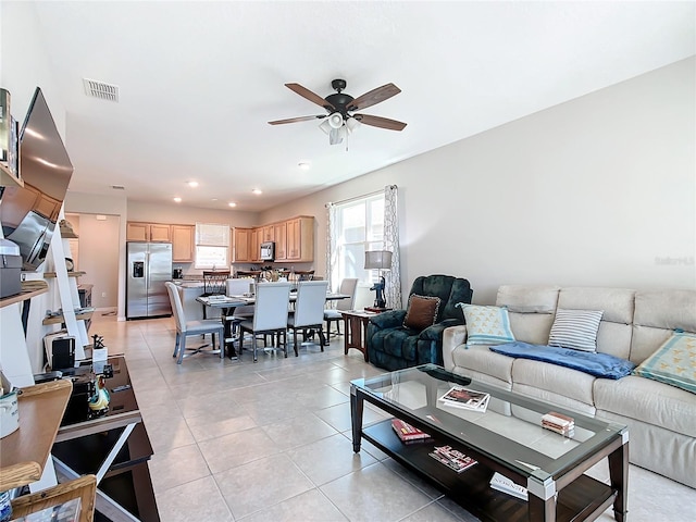 tiled living room featuring ceiling fan