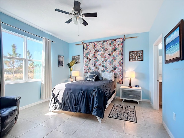 bedroom with ceiling fan and light tile patterned flooring