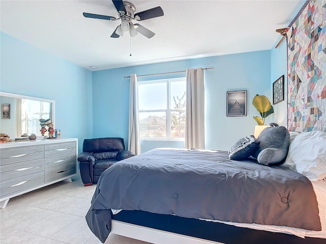 tiled bedroom featuring ceiling fan