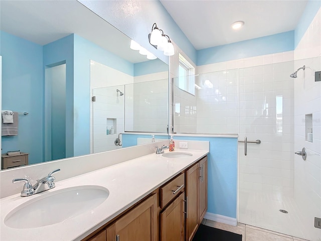 bathroom with tile patterned flooring, vanity, and an enclosed shower