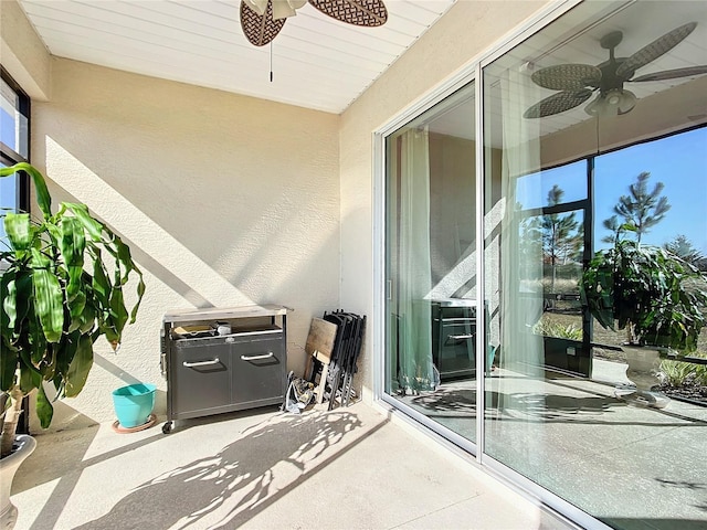 balcony with ceiling fan and a patio