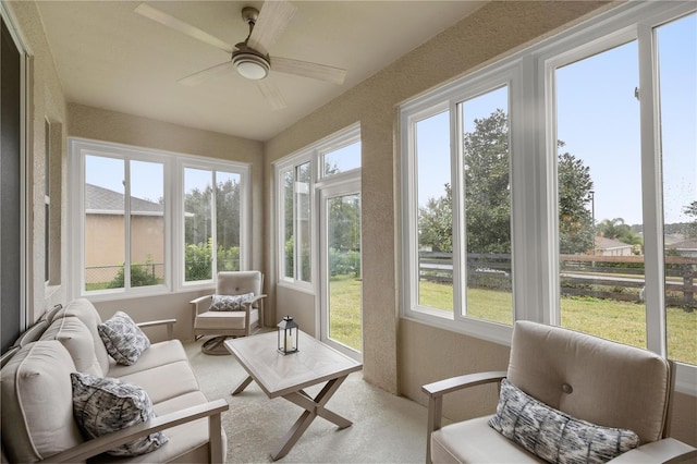 sunroom with ceiling fan and a healthy amount of sunlight