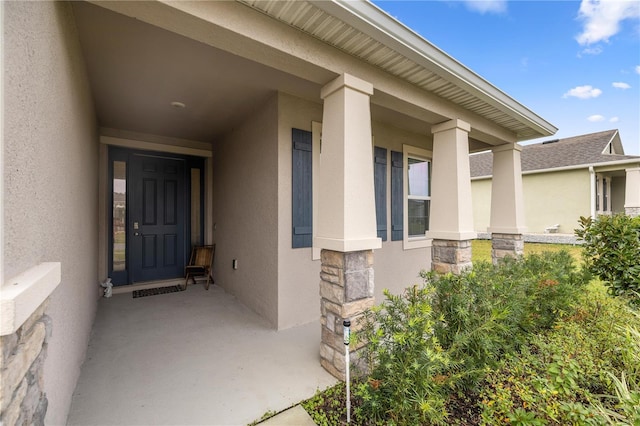 entrance to property featuring covered porch