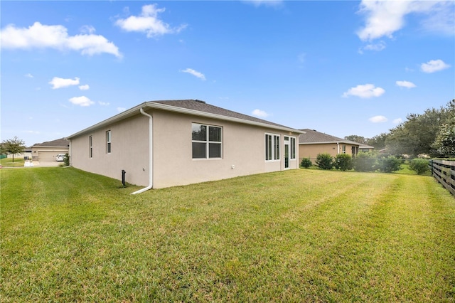 rear view of property with a yard