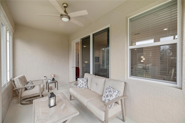 sunroom / solarium featuring ceiling fan