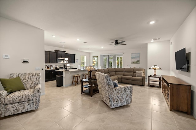 tiled living room with ceiling fan