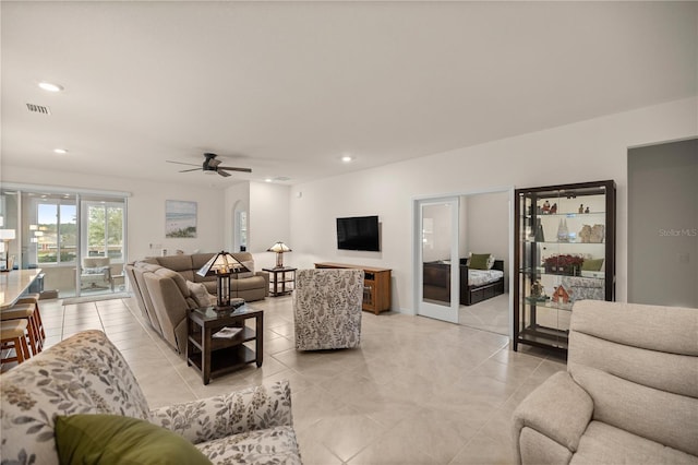 tiled living room with ceiling fan