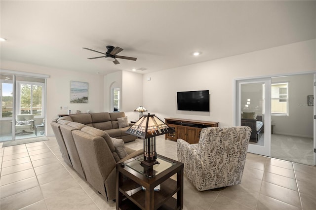 living room with light tile patterned floors and ceiling fan