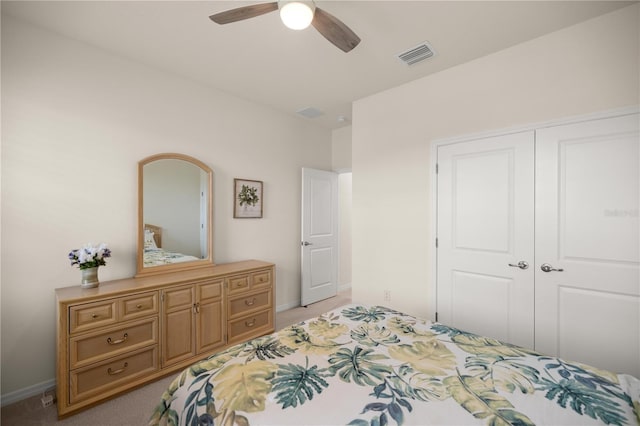 carpeted bedroom with ceiling fan and a closet