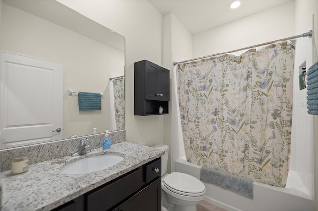 full bathroom featuring shower / tub combo with curtain, vanity, and toilet