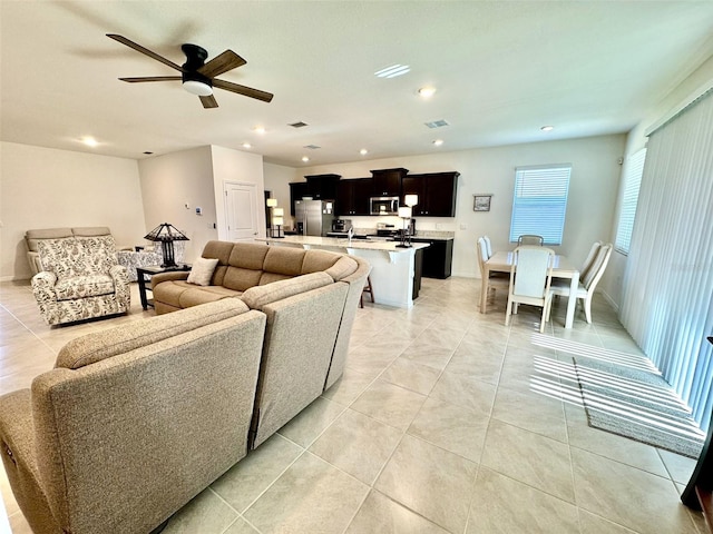 tiled living room featuring ceiling fan